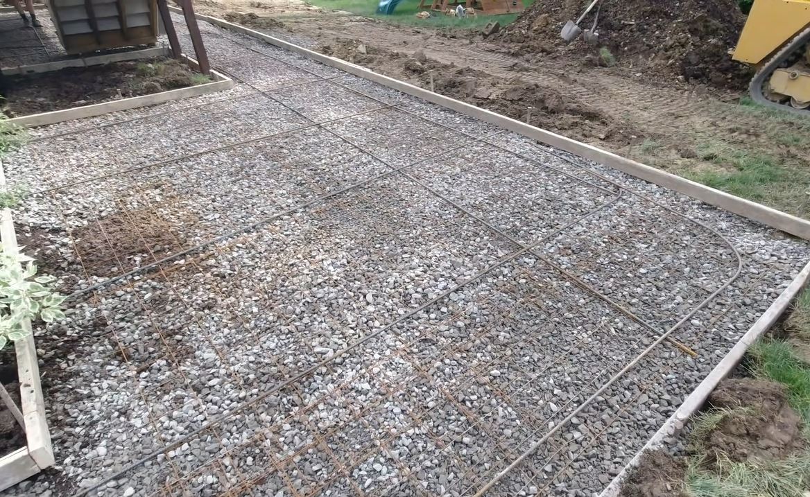 concrete patio preparation gravel base rebar reinforcement wooden forms