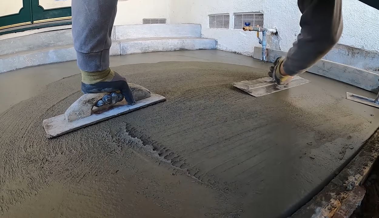 professional concrete finishing hand trowel smoothing wet surface